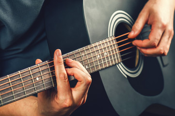 Obraz na płótnie Canvas a man plays a guitar