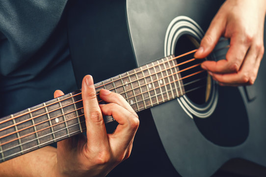 a man plays a guitar