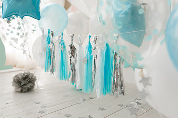 Baby birthday decorated room with white and blue balloons