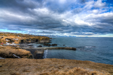A beautiful Icelandic landscape and sea with a dramatic cloudscape in mid march