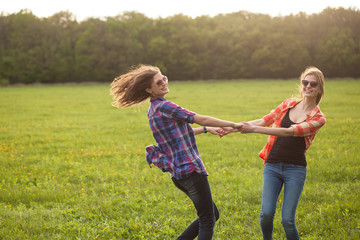 Two young women dancing outdoors