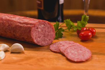 Piece of Italian salami with some slices