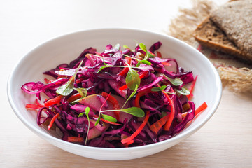 Red Cabbage salad with apples and pecan nuts for Christmas dinner. Vegetarian dish.