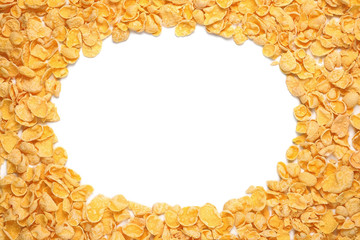 Pile of cornflakes isolated on white with oval copy space. Top view.