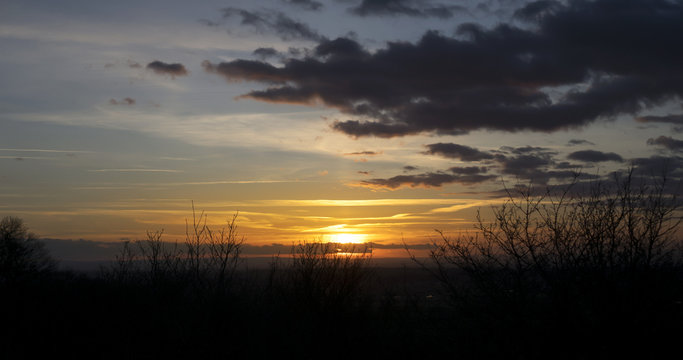 Wild grass silhouette against the beautiful sunset, Silhouestte of Meadow with dramatic surise and couldy sky in evening at countryside in England