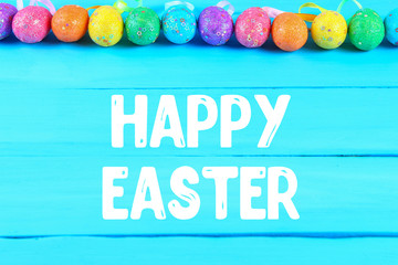 Colorful easter egg on blue pastel color wood background with space. Happy easter.