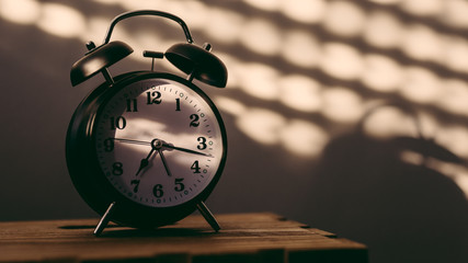 Alarm clock on night table in bedroom