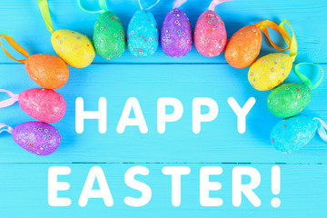 Colorful easter egg on blue pastel color wood background with space. Happy easter.