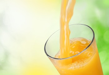 Orange juice glass on background