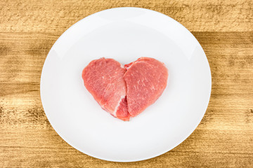 Raw meat in the shape of a heart.