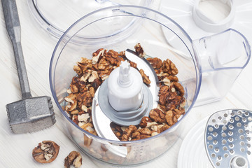 Kernel walnuts in a food processor ready to be crushed