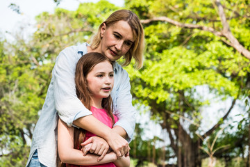 Fototapeta premium Mother and daughter relaxing in a park. Family and lifestyle concept