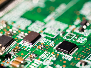 close-up of circuit board with integrated circuits, resistors and capacitors.