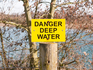 yellow and black sign danger deep water lake