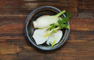 Organic Fennel Bulbs with Salt and Pepper ready to cook over Wooden Background. Isoalted.