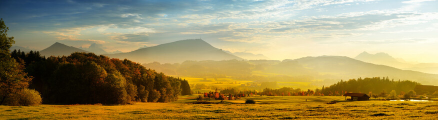 Breathtaking lansdcape of Austrian countryside on sunset. Dramatic sky over idyllic green fields of...