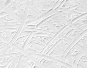 White background with a paint texture. Smears brush artist on the canvas with a pattern of stripes and intersections of endless lines, a template for wallpaper with natural strokes.