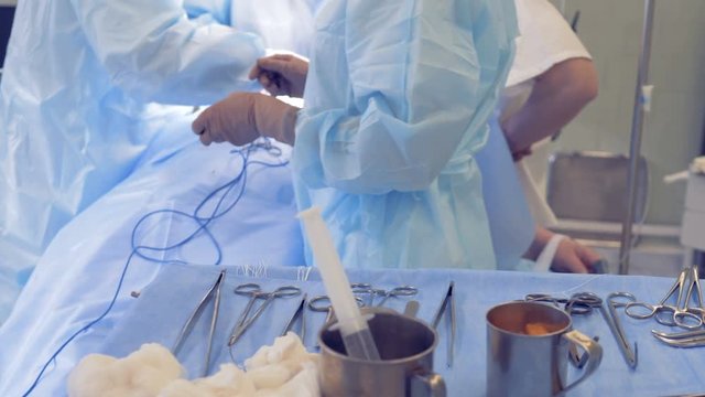 Nurse's operating table with surgery instruments.