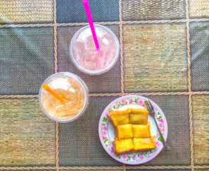toast with butter and condense milk with plastic glass
