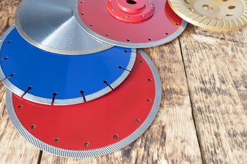 Diamond discs for concrete, reinforced concrete, granite and stone on the background of a wooden...