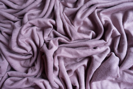 Simple pink viscose fabric in soft folds from above