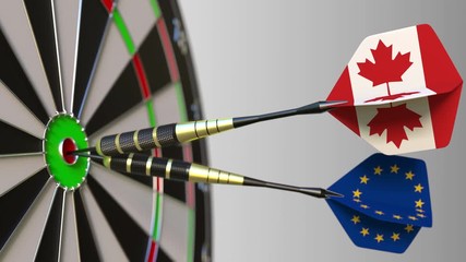 Flags of Canada and the European Union on darts hitting bullseye of the target. International cooperation or competition conceptual animation