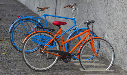 A pair of bicycles parked in the city