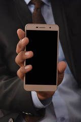 Man holding blank screen smartphone professionally isolated on white background