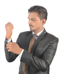 Businessman correcting cuff very professionally isolated on white background
