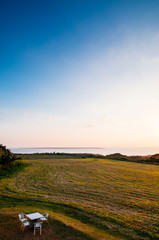 Fototapeta premium Wide Grass field by the ocean in Ishigaki island, Okinawa, Japan