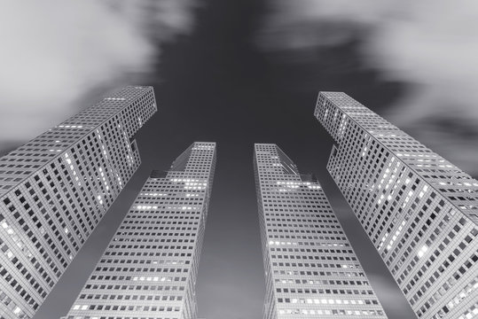 Architecture In City, Hight Modern Building With Moving Clouds In The Sky At Night. Picture For Add Text Message. Backdrop For Design Art Work.