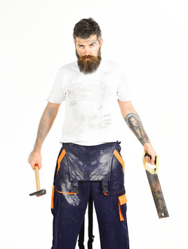 Man with beard in dirty dusty boilersuit. Builder, plasterer, repairman