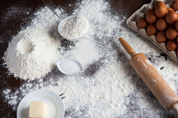 Image of hard working male cook or baker with dark skin wears apron, sheets well made dough, going...