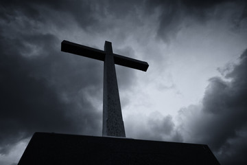 Easter Sunday Concept: Silhouette the cross over blurred cloudy background