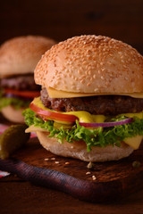 Fresh burger closeup. Wooden rustic background. Top view