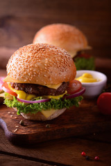 Fresh burger closeup. Wooden rustic background. Top view
