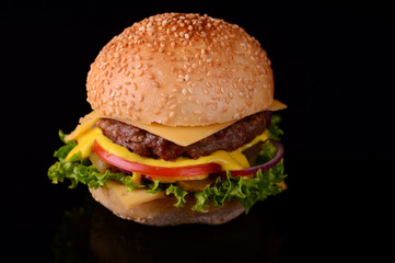 Fresh burger closeup. Black background. Top view