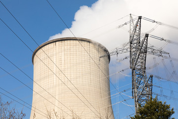 cooling tower with blue sky and power pole