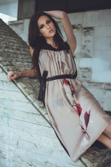 Young beautiful girl with brown-haired woman in dress, walking down the street, the city and posing. Fashion photo