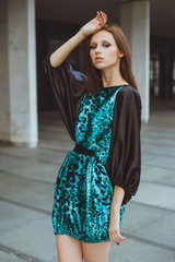 Young beautiful girl with brown-haired woman in dress, walking down the street, the city and posing. Fashion photo