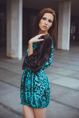 Young beautiful girl with brown-haired woman in dress, walking down the street, the city and posing. Fashion photo