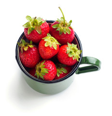 Fresh strawberries in enamel mug isolated on white