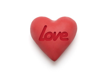 Red heart with imprinted love word over white background with clipping path