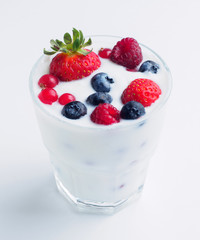Glass with berries in milk. isolated background