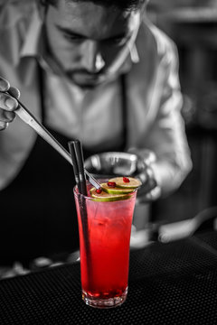 Bartender decorating non-alcoholic pomegranate cocktail