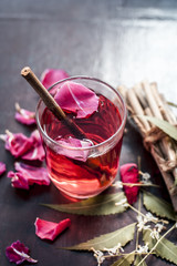 Indian Ayurvedic and Islamic way of doing brush with using miswak or Neem bark with rose water on wooden surface in dark Gothic colors.