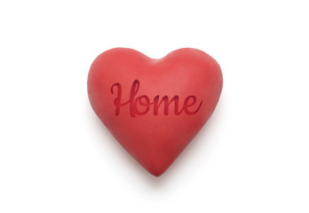 Red heart with imprinted home word over white background with clipping path
