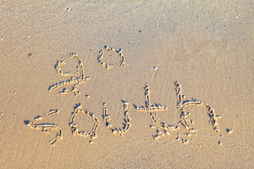 Go south written in the sand.