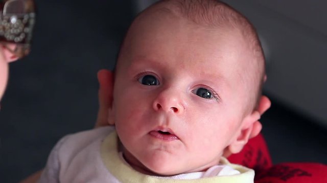 Closeup Portrait Of Newborn Baby Boy Looking At The Camera