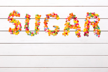 Colorful candy background with the word sugar